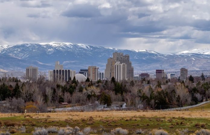 landscape view of the Reno central business district with snowcapped mountains in the distance beyond