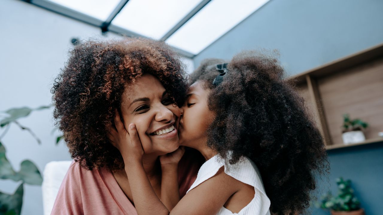 daughter showing affection to mom