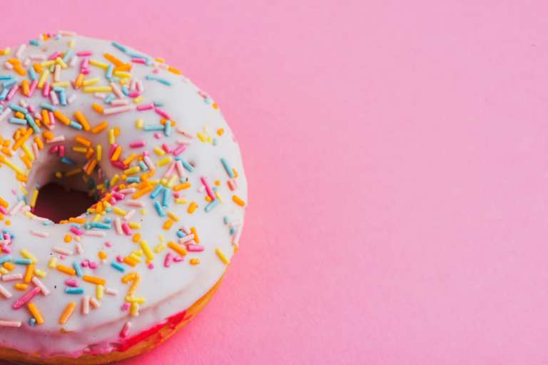 nashville bakery: up close of a doughnut on a pink background