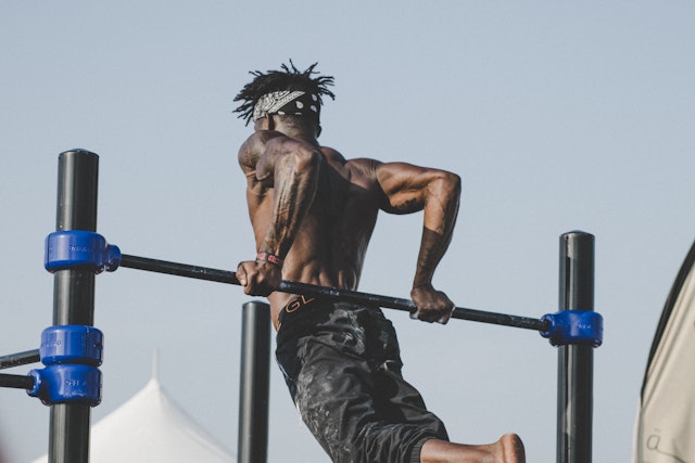 outdoor gym: man working out on bars outside