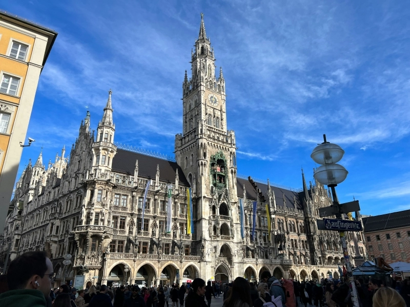 a group of people standing in front of a large building