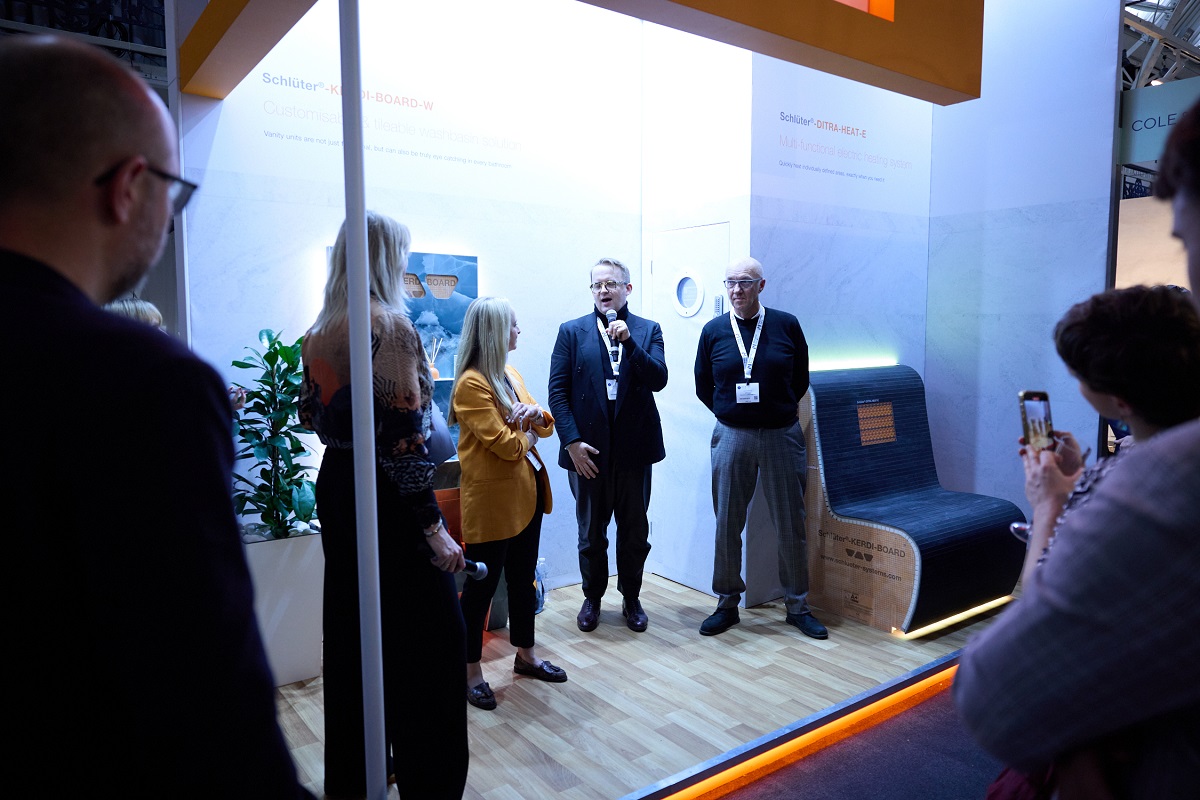 Sophie Harper leads a talk on the Schluter Systems stand at HIX 2024 with speakers, Elizabeth Walton, John Paul Pederson, and Martin Radley.