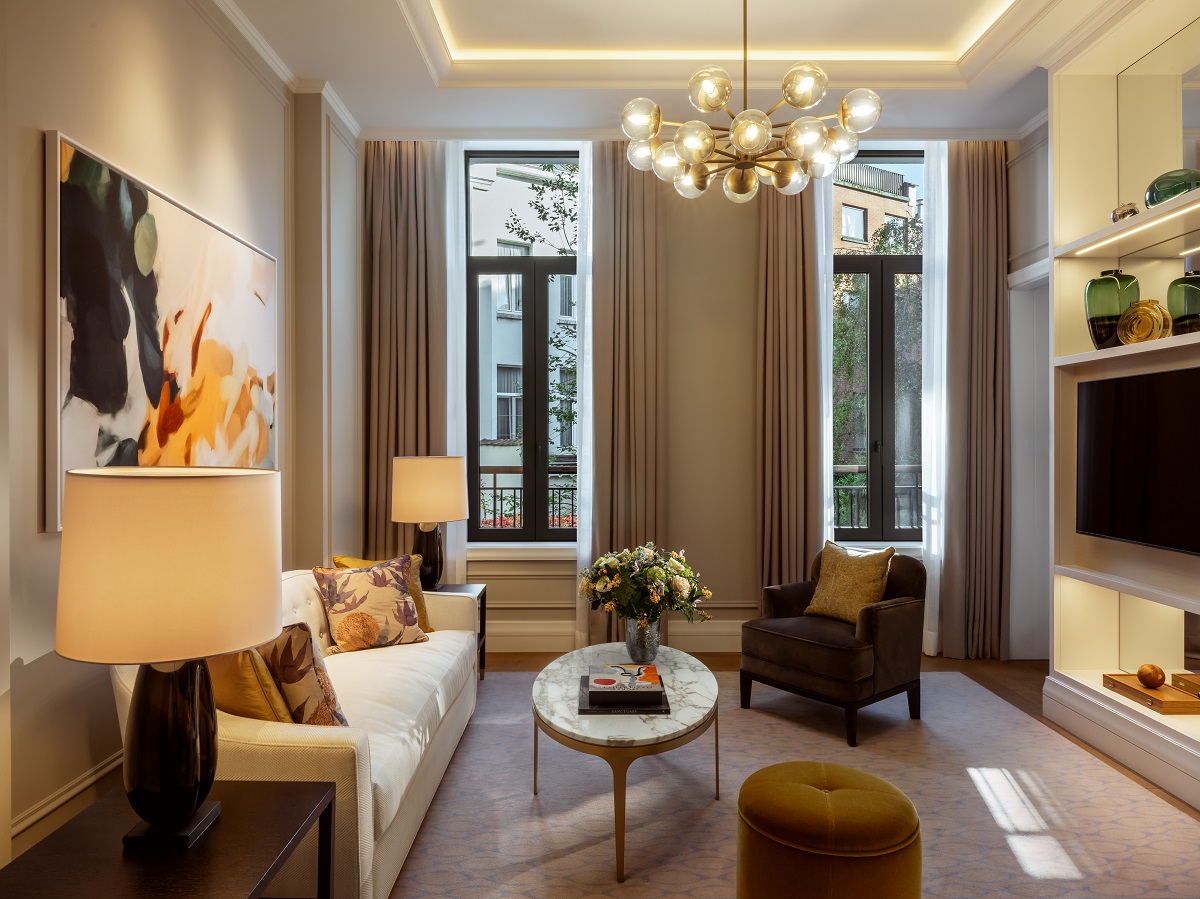 couch in front of windows in suite in Corinthia Brussels