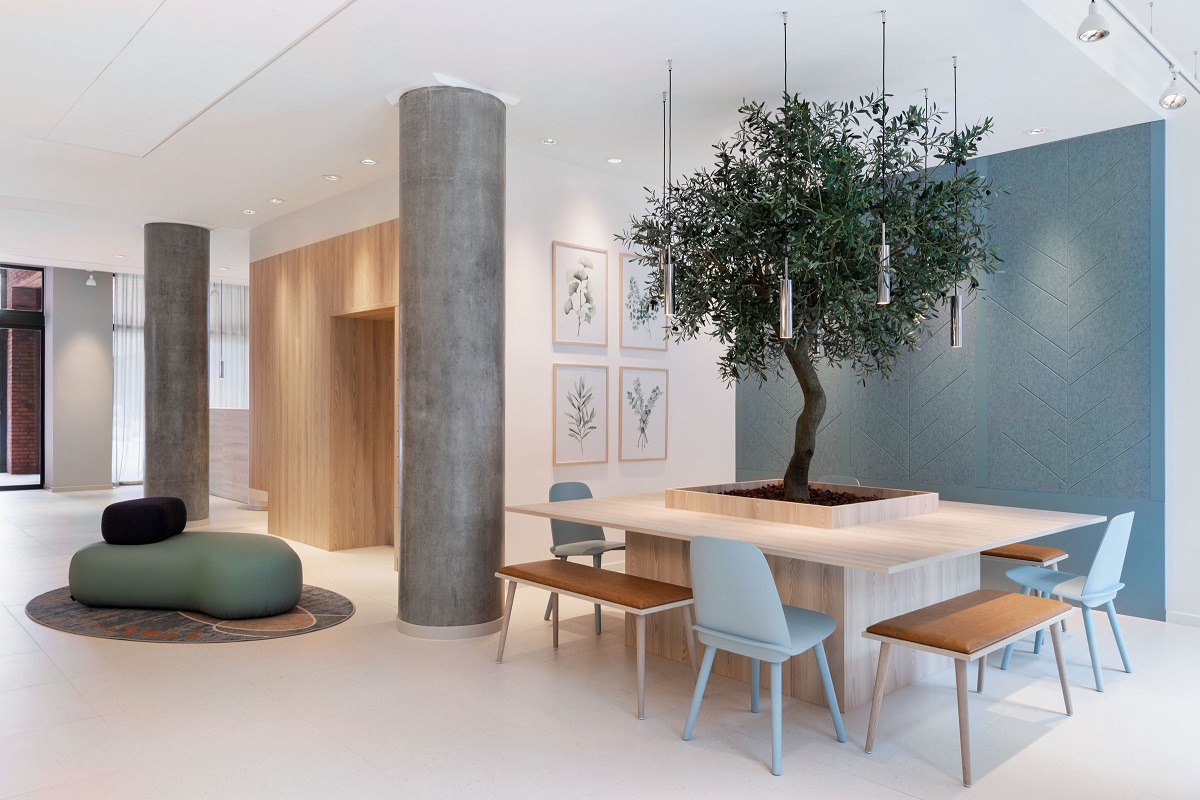 communal table around an olive tree in the lobby at Fairfield copenhagen