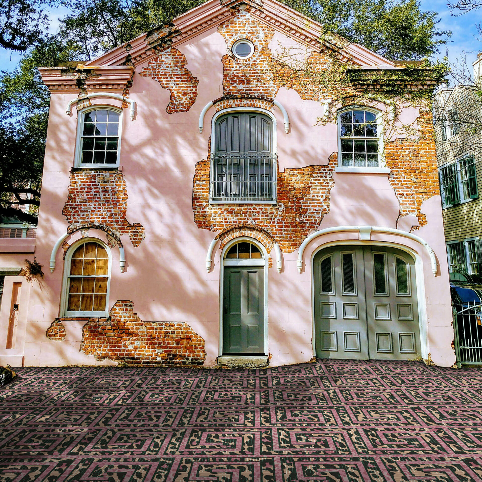 pink and brick house facade with Modieus carpet in foreground