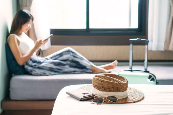 A guest using the hotel app to connect with front desk from her hotel room.