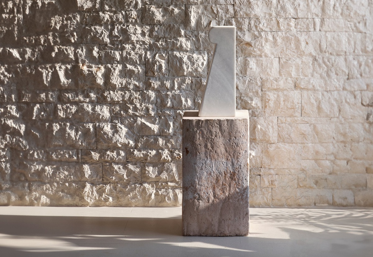 stone sculpture by Will Pryce against stone wall